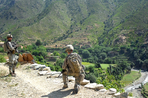 U.S. Army Sgt. 1st Class Steve Larocque looks back at Pfc. James Kelley during a patrol in Hajiabad, Konar province, Afghanistan, July 14, 2009. Larocque and Kelley are assigned to the 61st Cavalry Regiment's Company C, 3rd Squadron. The team hiked up to Hajiabad to meet with village elders. U.S. Army photo by U.S. Army Spc. Evan D. Marcy