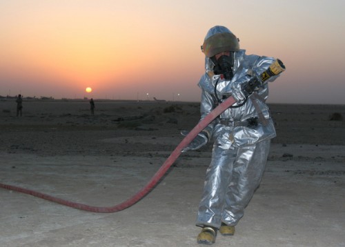 A firefighter heads toward a simulated burning aircraft during a mass casualty exercise aboard Al Asad Air Base, Iraq, Aug. 21, 2009. (U.S. Marine Corps photograph by Staff Sgt. Jayson Price)