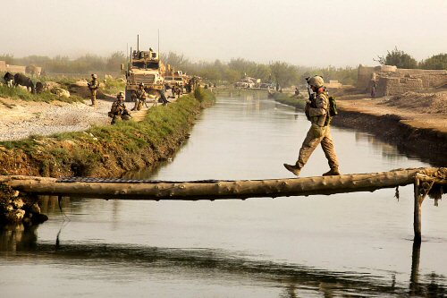 Sgt. Brian Kightlinger, with Company B, 1st Battalion, 5th Marine Regiment, crosses a bridge during a security patrol in the Nawa district of the Helmand Province of Afghanistan Sept. 5, 2009. The Marines conduct security patrols to decrease insurgent activity and gain the trust of the Afghan people. The 1st Battalion, 5th Marine Regiment is deployed with Regimental Combat Team 3, which conducts counterinsurgency operations in partnership with Afghan National Security Forces in southern Afghanistan.  (Photo by Cpl. Artur Shvartsberg)
