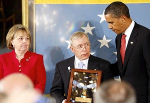 President Barack Obama posthumously awards Army Sgt. 1st. Class Jared C. Monti from Raynham, Mass., the Medal of Honor for his service in Afghanistan, to his parents Paul and Janet Monti, Thursday, Sept. 17, 2009, in the East Room of the White House in Washington. (AP Photo/Charles Dharapak)   Original Filename: Obama_WHCD124.jpg